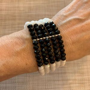 Black and white bead bracelet.  Elastic so rolls on / off the wrist easily.
